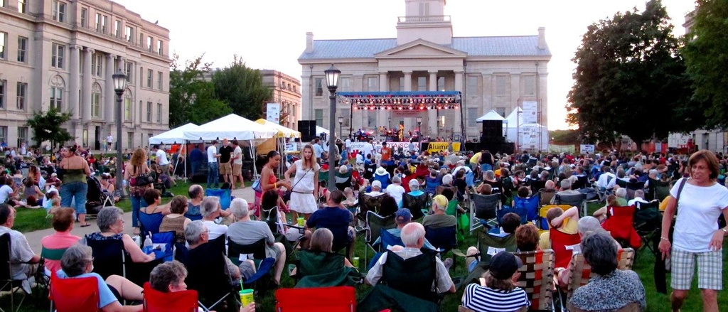 Performers on stage in front of the Old Capitol at Jazz Fest