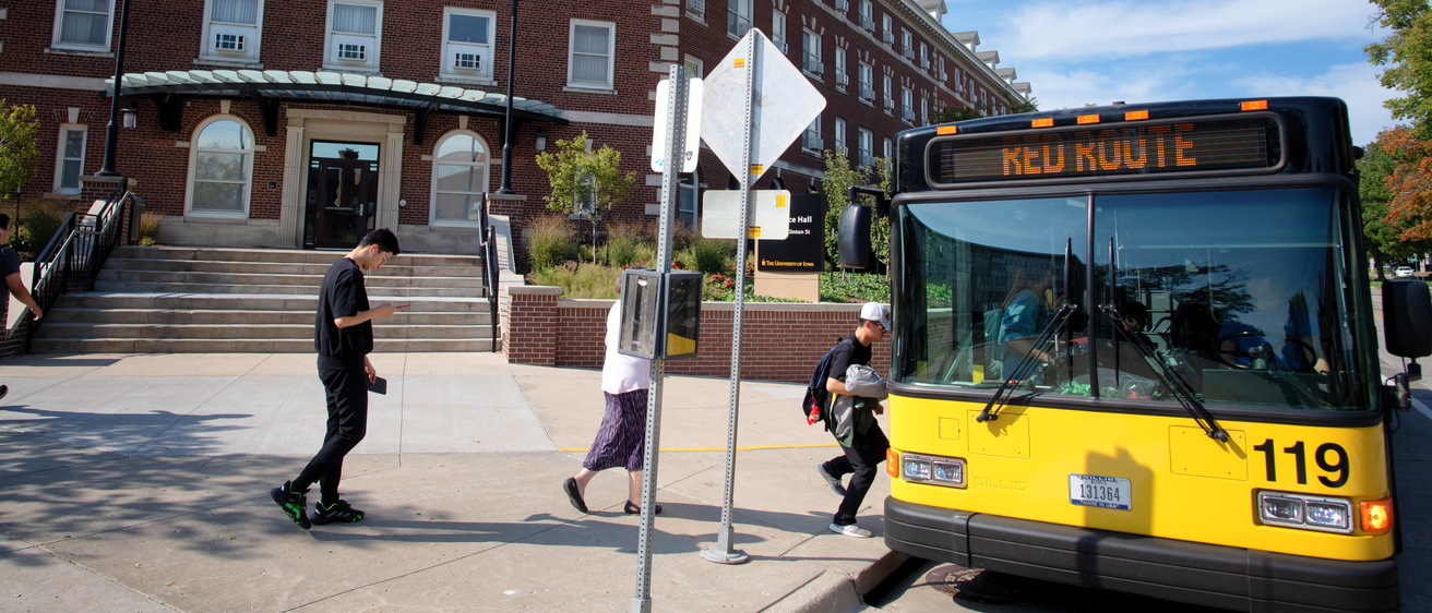 Students board a CAMBUS at Currier Hall