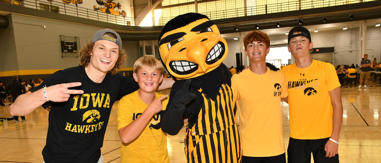 herky the hawk standing with students