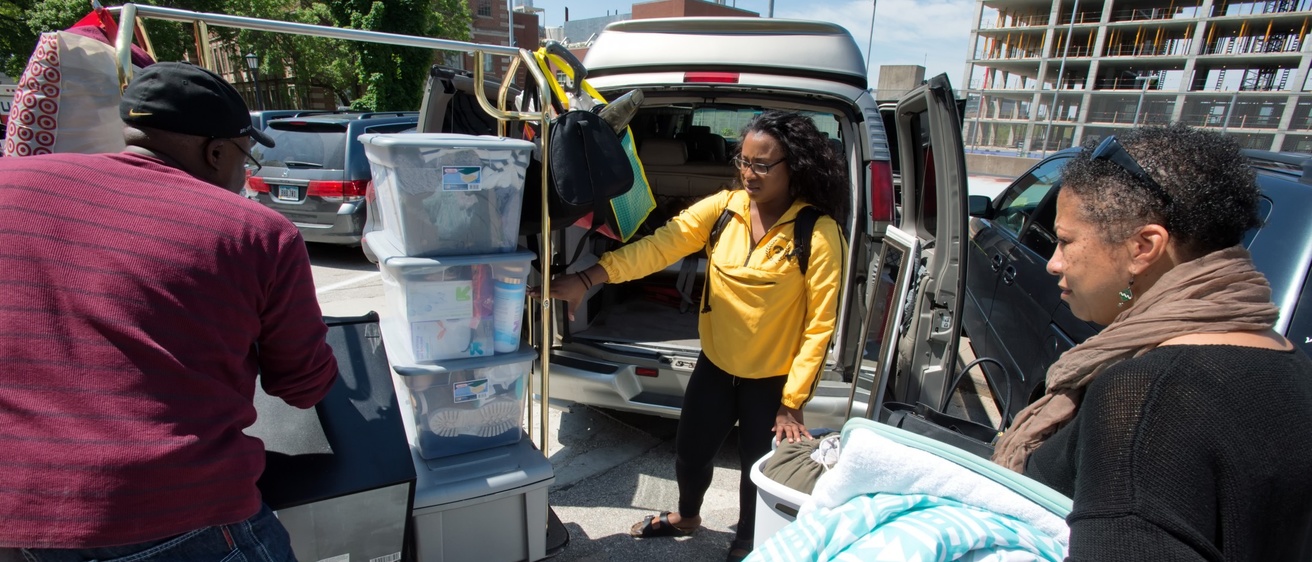 Family and student loading up a vehicle on move out day