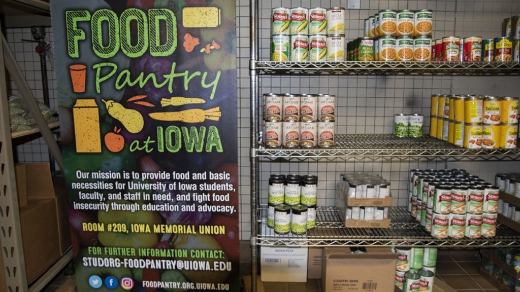 Can goods slowly fill the shelf at the U of Iowa food pantry