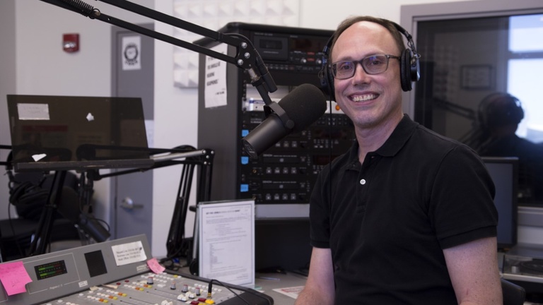 Bret Gothe in a recording studio, recording the PFN Podcast